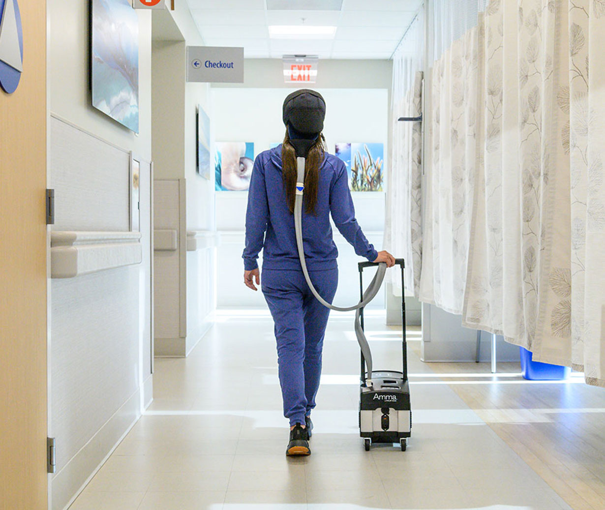 Patient walking thru infusion center while Scalp Cooling to preserve hair during chemo