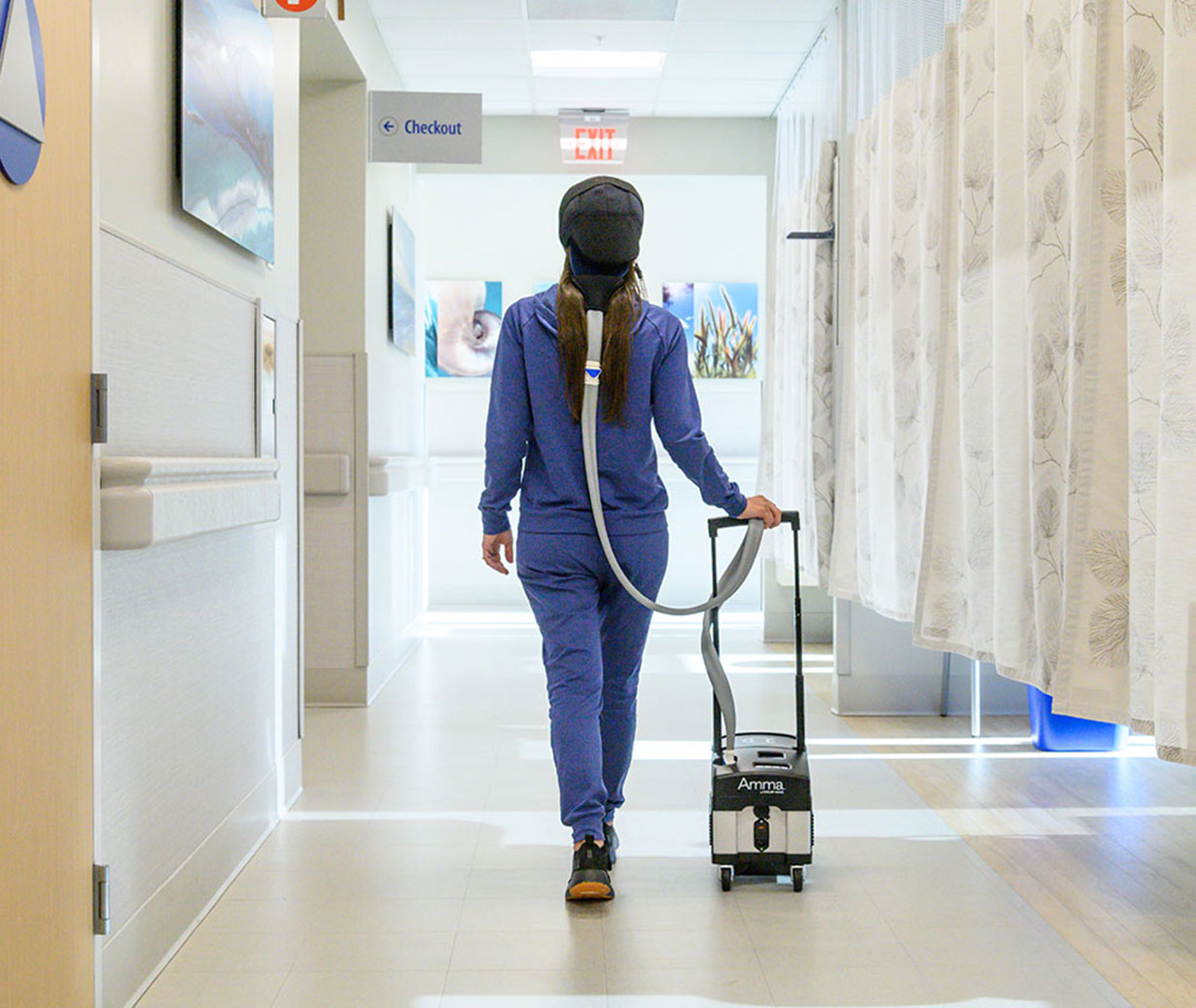 Scalp Cooling vs Cold Capping. Patient walking thru infusion center while Scalp Cooling to preserve hair during chemo